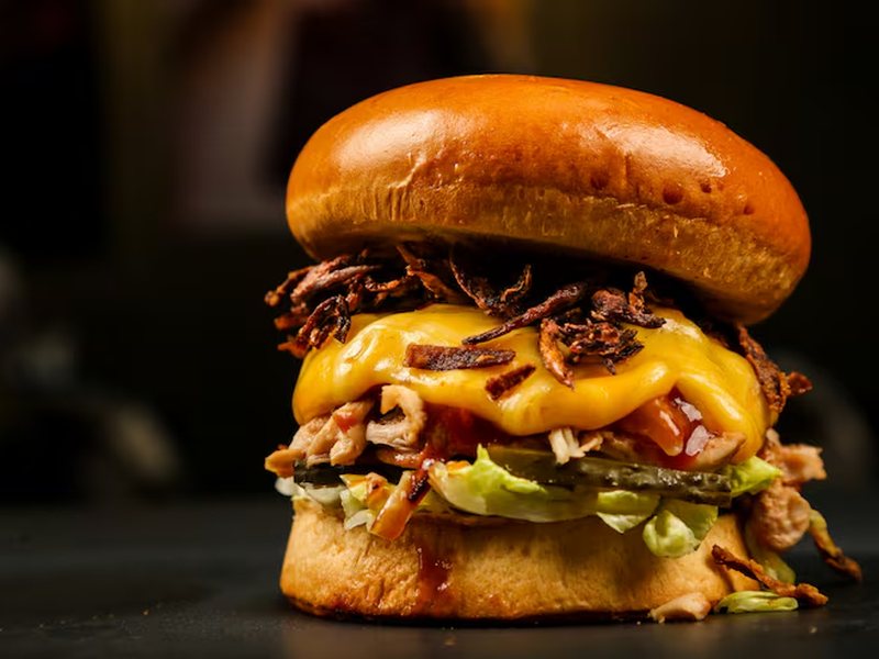 A stacked burger with melted cheese
